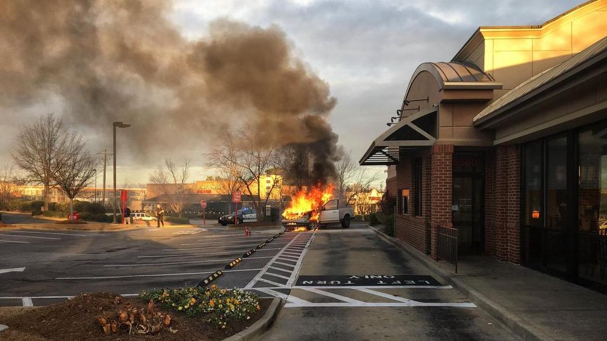 Vehicle catches fire in Chick-Fil-A drive thru.