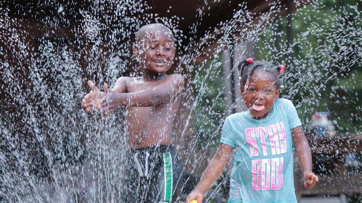 Christopher and Madison Davis cool off in the sprinkler at their grandmother’s house in the summer of 2016. Columbia is ranked one of the hottest cities on the East Coast.