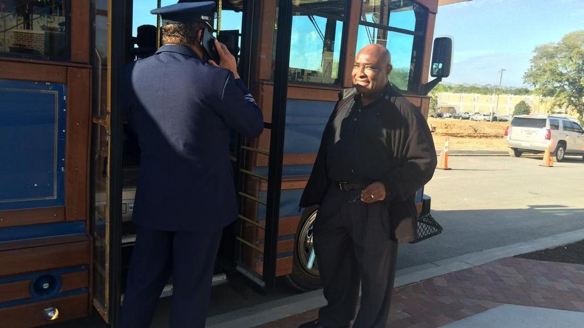 Earl Jay of Columbia, right, helps Norman Summers greet attendants at Sunday’s Night of Joy. Attendants parked in lots far from the stadium and shuttled to the front steps.