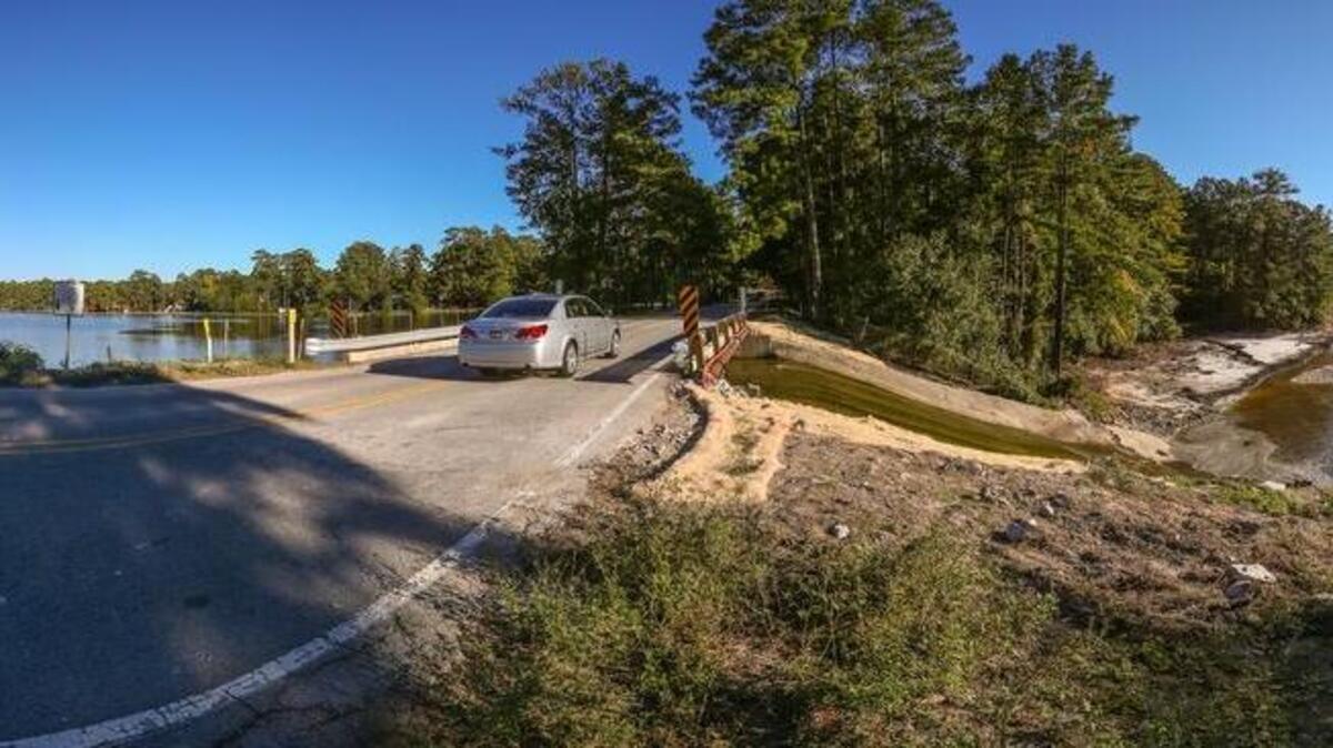 
Some residents question whether the Chatsworth road bridge over the Windsor Lake dam is safe to drive across. Windsor Lake, left, is still at full pool but the water is gone on the other side due to dam breaches downstream. 10/19/15
