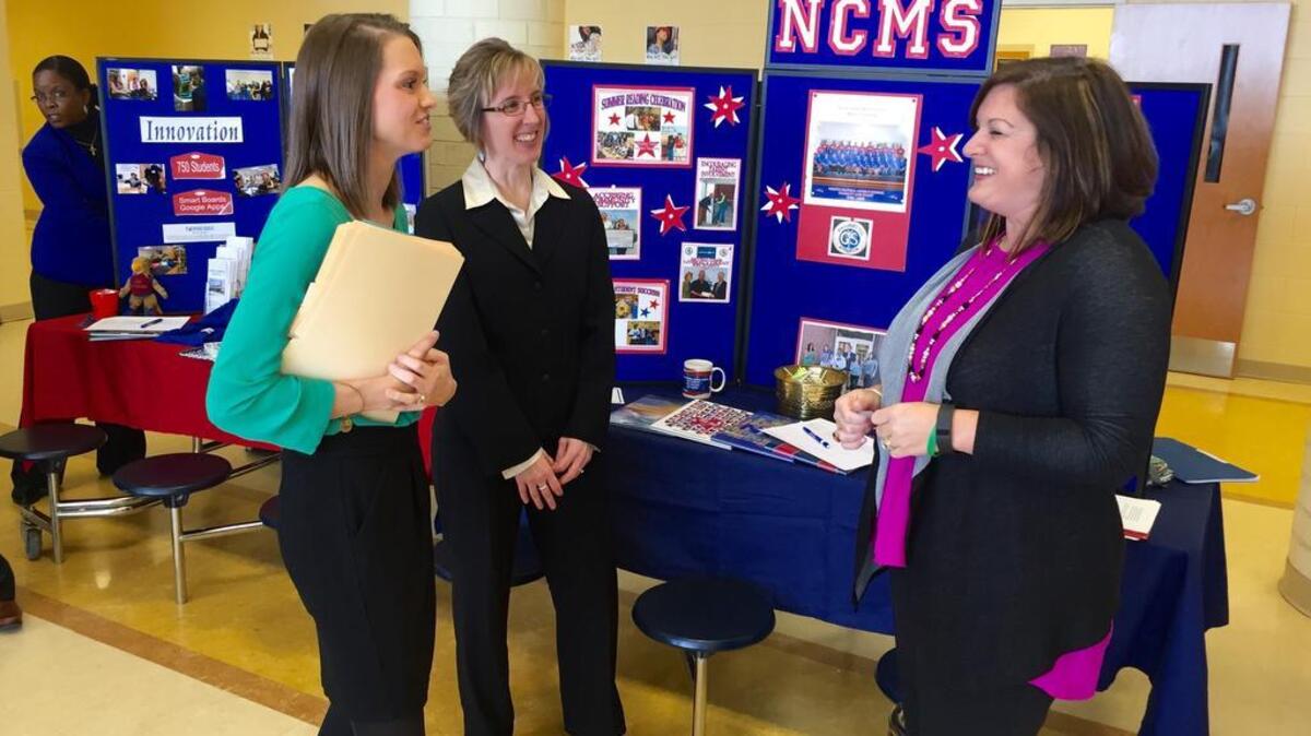 Anna Moser, left, talks with North Central Middle School teachers Jennifer Mills and Jodie Kahler at Kershaw County school district’s teacher recruitment fair.