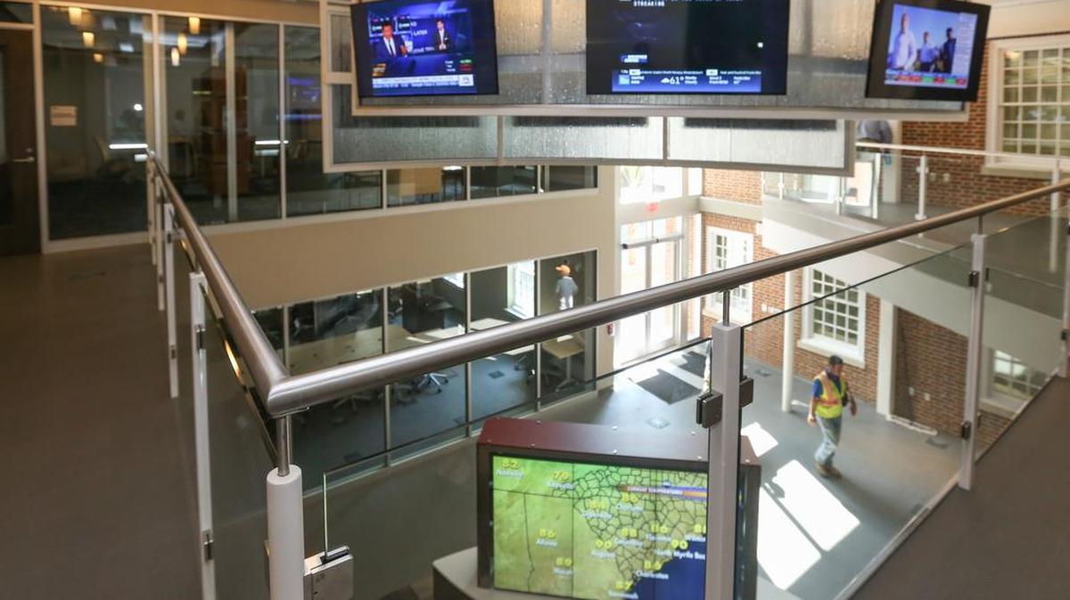 
The lobby of the University of South Carolina's School of Journalism features multiple television screens. The school has moved to the renovated School of Public Health on the Horseshoe. The school had formerly operated out of the Carolina Coliseum. 
