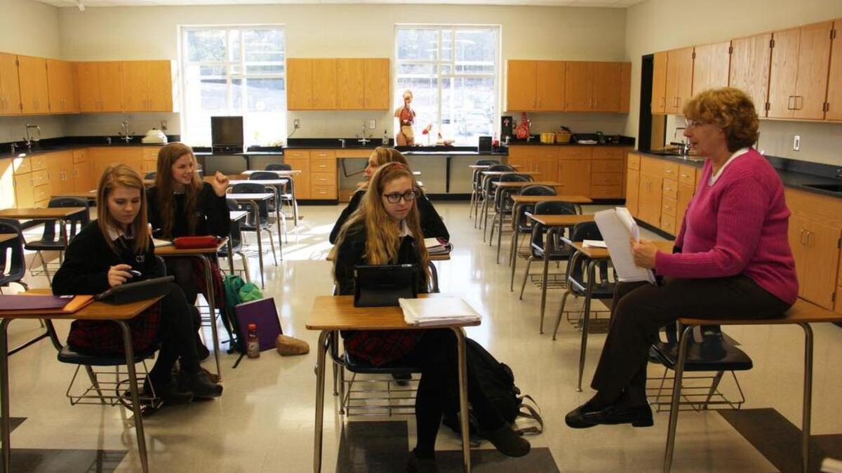 Maryann Commins, right, teaches students at the new Cardinal Newman School campus Tuesday morning.