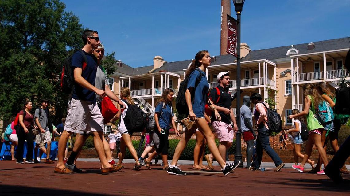 
University of South Carolina students make their way past the Russell House on campus. 
