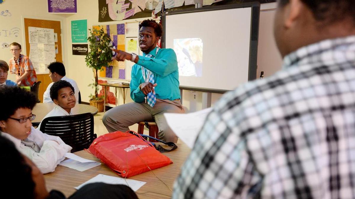 Walter Lee, a mentor and teacher at Tanglewood Middle School, speaks during a recent meeting of the student accountability program, Never Leave Brothers Behind.