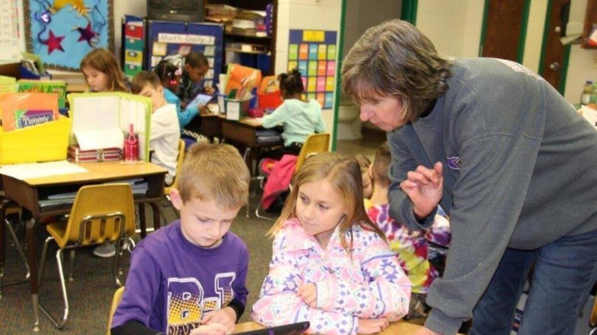 Teacher Gail Asbill, right, works with first-grade students at Batesburg-Leesville Primary School. All Lexington 3 schools need upgraded wiring as instruction increasingly relies on digital technology, a study says.