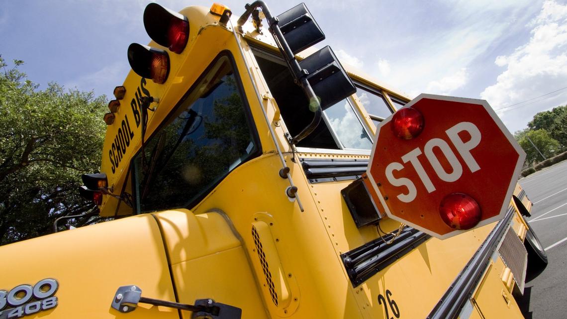 A woman was hit by a motorcycle while crossing the street with her child at a school bus stop in Brighton, Alabama, on Feb. 28, sheriff’s deputies said.
