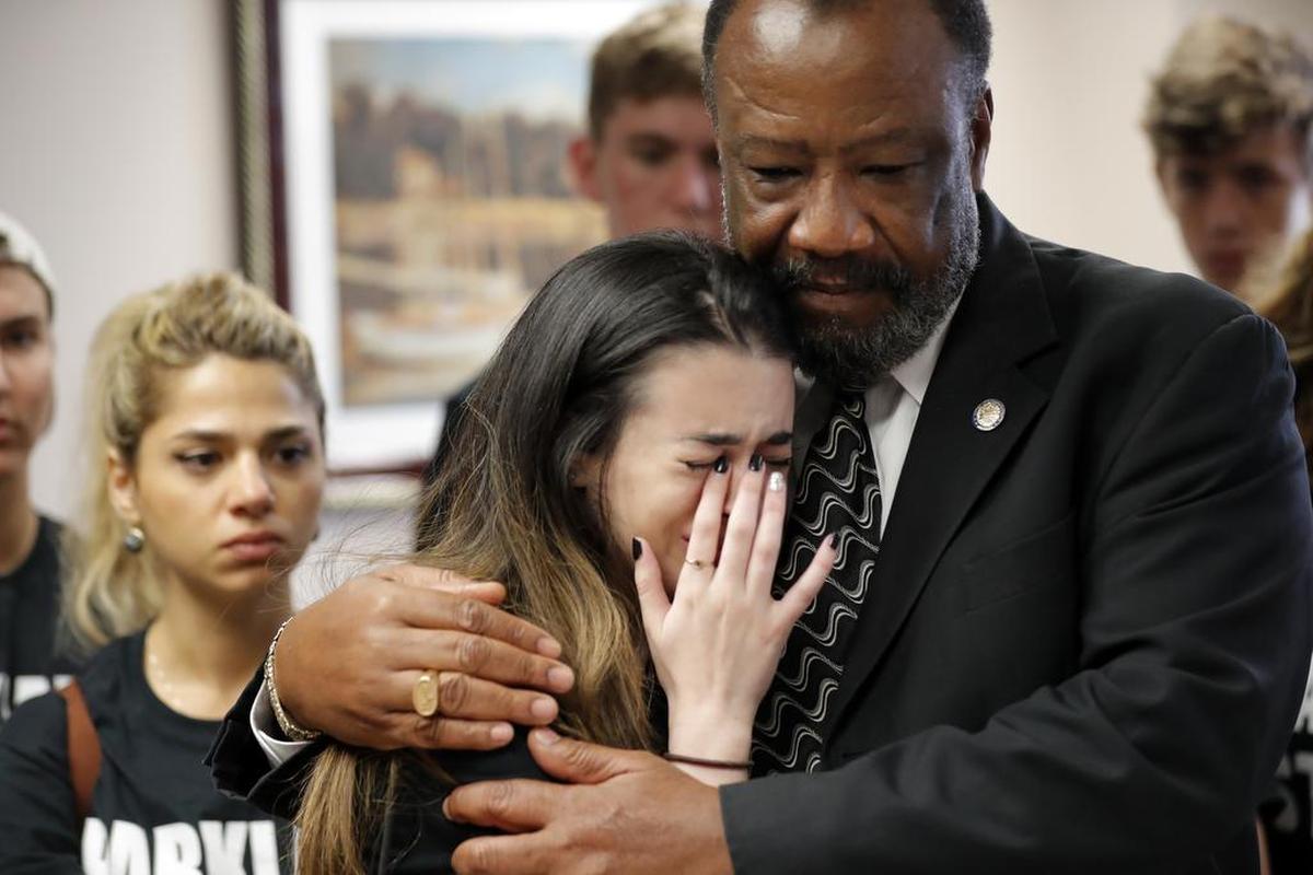 Aria Siccone, 14, a 9th grade student survivor from Marjory Stoneman Douglas High School, where more than a dozen students and faculty were killed in a mass shooting on Wednesday, cries as she recounts her story from that day, while state Rep. Barrinton Russell, D-Dist. 95, comforts her, as they talk to legislators at the state Capitol regarding gun control legislation, in Tallahassee, Fla., Wednesday, Feb. 21, 2018.