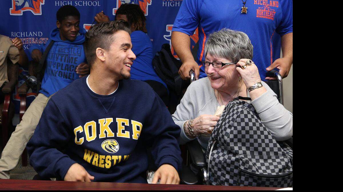 
Richland Northeast senior wrestler Javier Moreno talks with Irene “Grandma Carmen” White after signing to wrestle at Coker College during a ceremony at the school, Thursday, April 23, 2015.
