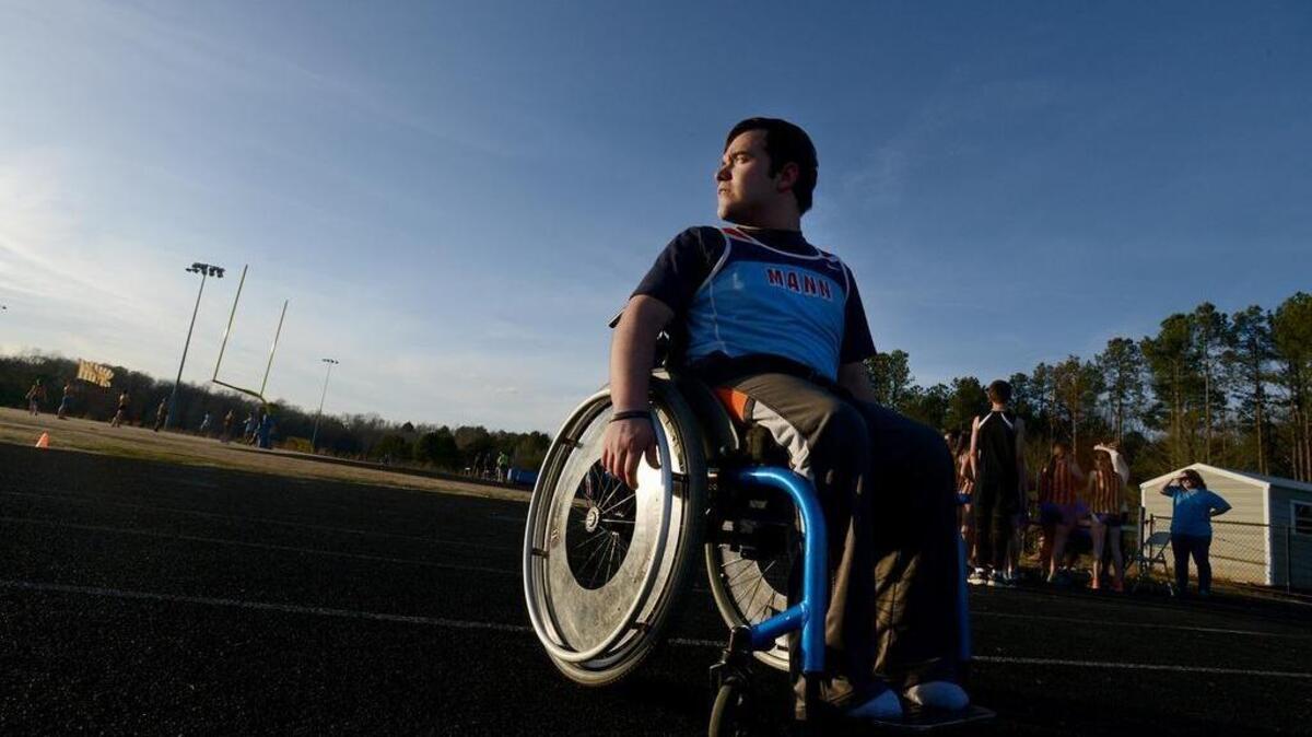 Thomas Clark, a member of the JL Mann High track team, looks over the Wren High track before getting into his racing chair to compete in the 100 meter race on Thursday, March 10, 2016. Clark, who has spina bifida, has been training with a special racing chair.