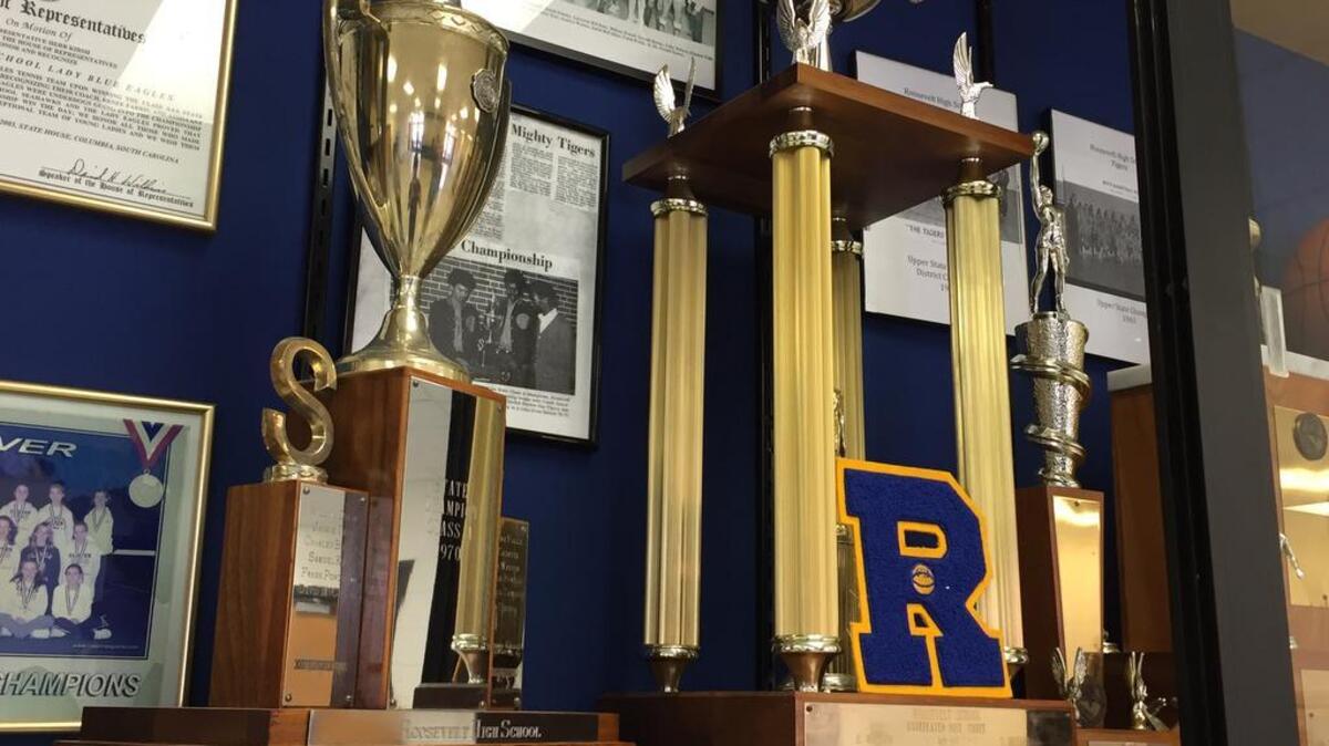 Clover administrators pulled Roosevelt’s championship trophies out of storage last winter and displayed them in the school’s trophy case alongside the Clover High memorabilia.