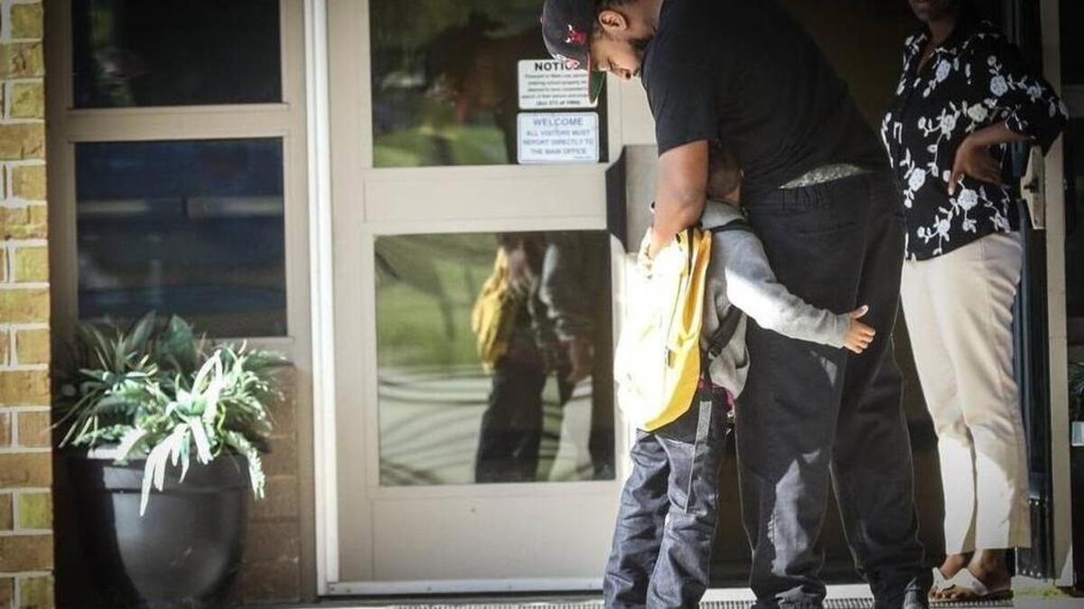 
Antwan Lindsey hugs his son Tyree before school at Polo Road Elementary in Richland 2. 
