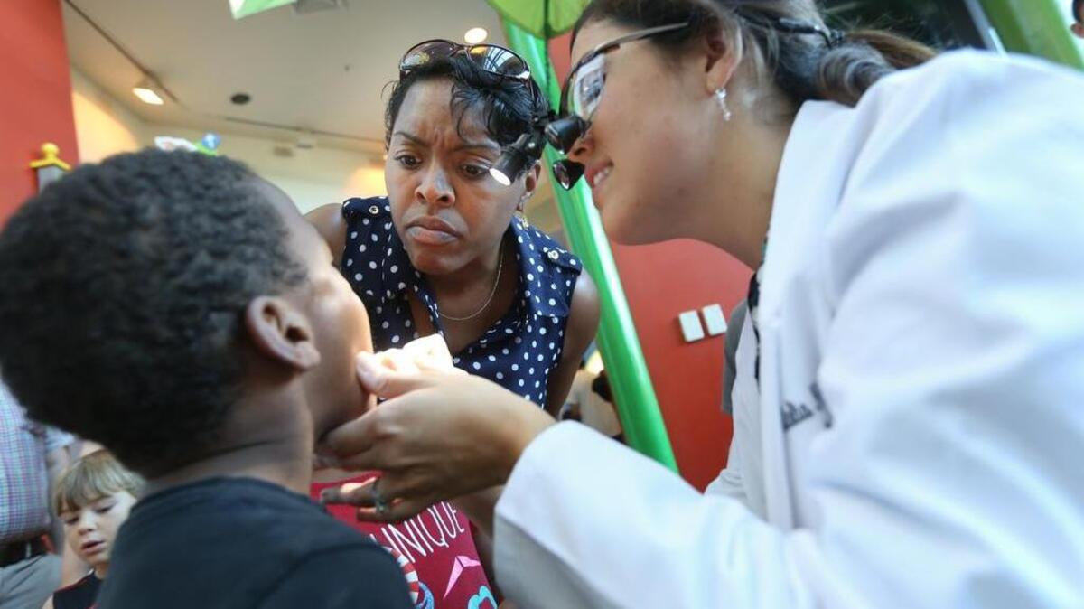 
Dr. Natalia Nunez Antley shows Rosie Quiller her son Dawson's teeth during EdVenture's Countdown to Kindergarten. 
