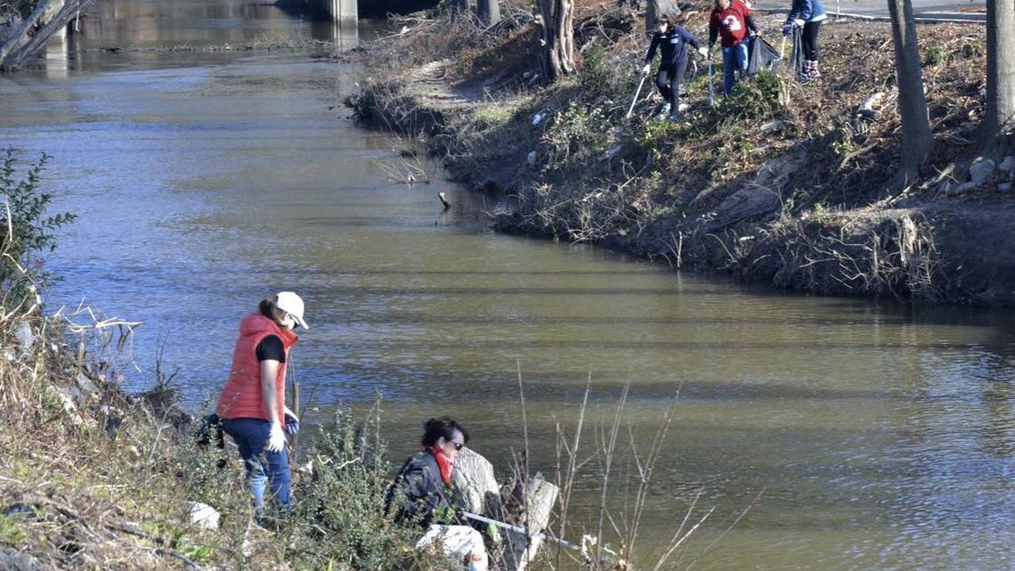 A new plan for a greenway along Gills Creek calls for a pathway to start near Fort Jackson Boulevard and move downstream. In the photo above, University of South Carolina students participate in the January 2016 Martin Luther King Jr. Day of Service by cleaning up Gills Creek near Fort Jackson Boulevard. That area was affected by flooding in October 2015.