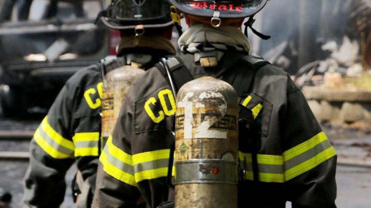 Columbia firefighters would get 150 new air packs to replace aging ones like those pictured in this scene from a fire earlier this month.