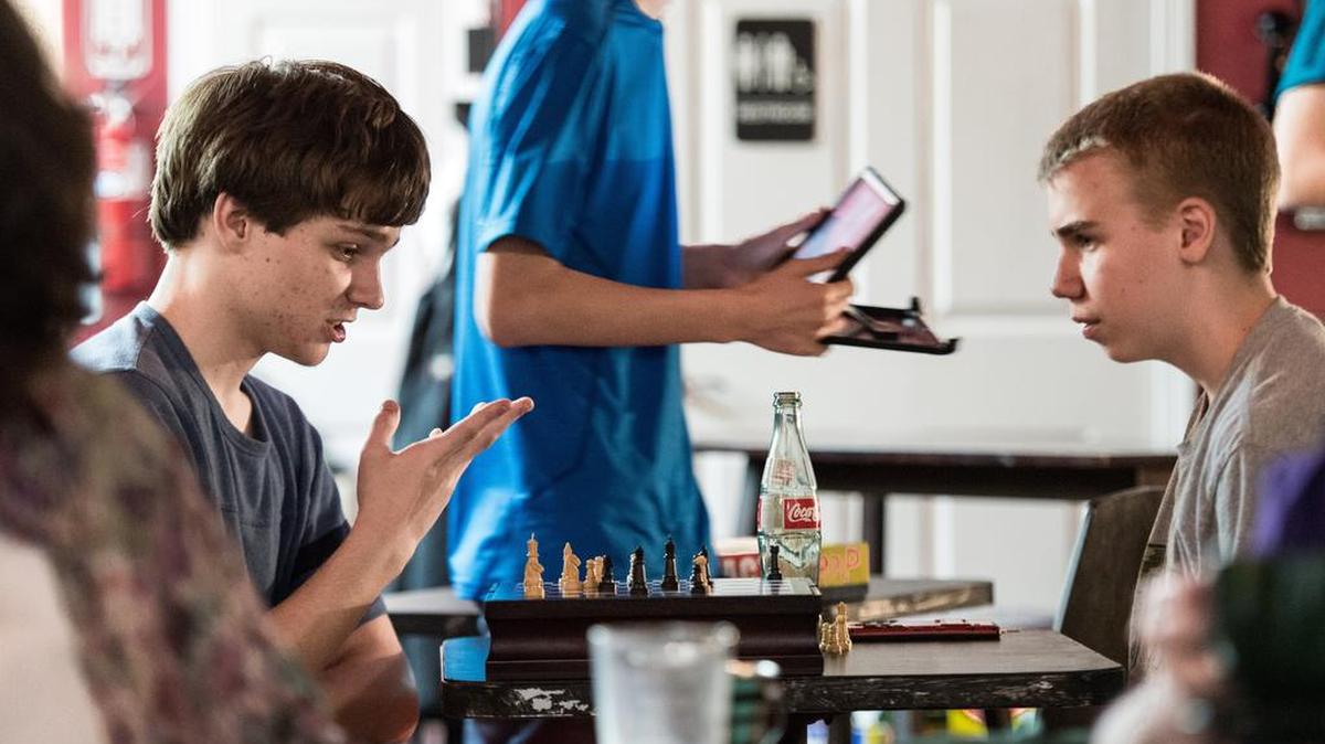 Yannick Felsenhardt, left, and Christopher Walker play chess at the Local Buzz coffee shop during a Breakfast Club meeting Friday night in Shandon. The Breakfast Club is a social group for teens with social anxiety, ADHD, Aspergers, autism and their parents seeking common ground friendships in a welcoming environment.