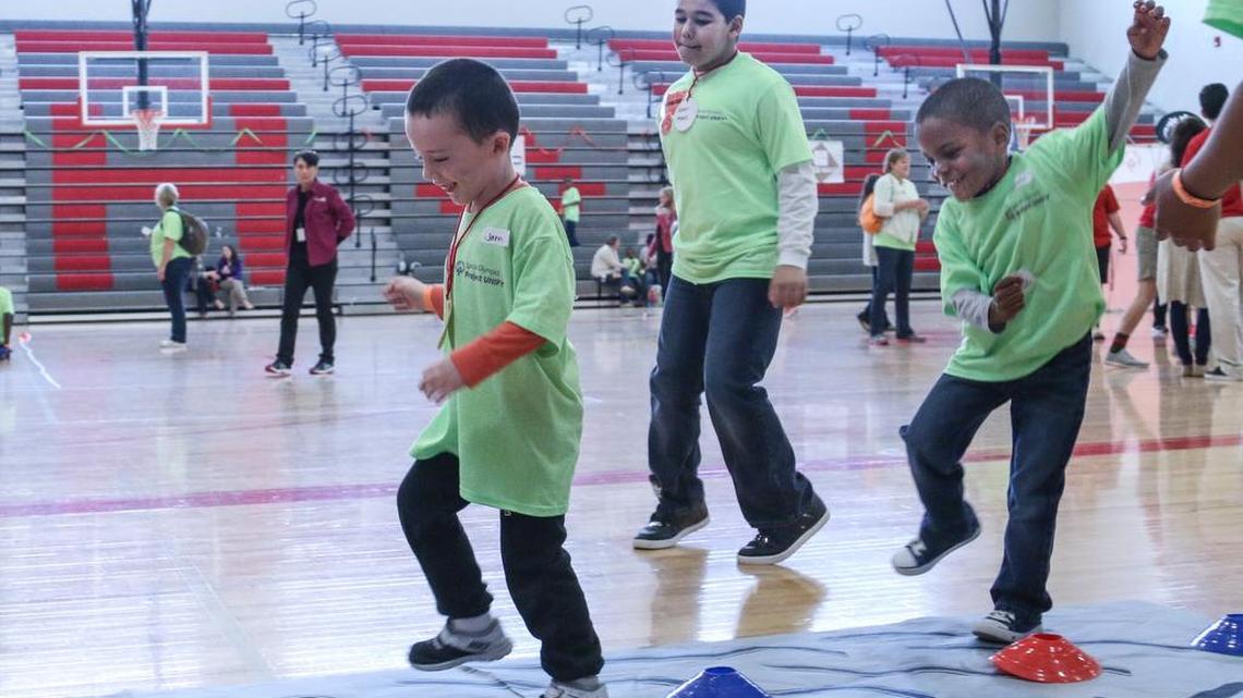James Beam, left and Noah Eldridge run an obstacle course as fifth grader Russell Mendez keeps pace alongside. Harbison West Elementary School paired fifth graders with developmentally disabled students to compete in a young athletes expo at Spring Hill High School. Students from Chapin Elementary, H.E. Corley and Spring Hill High School also participated.