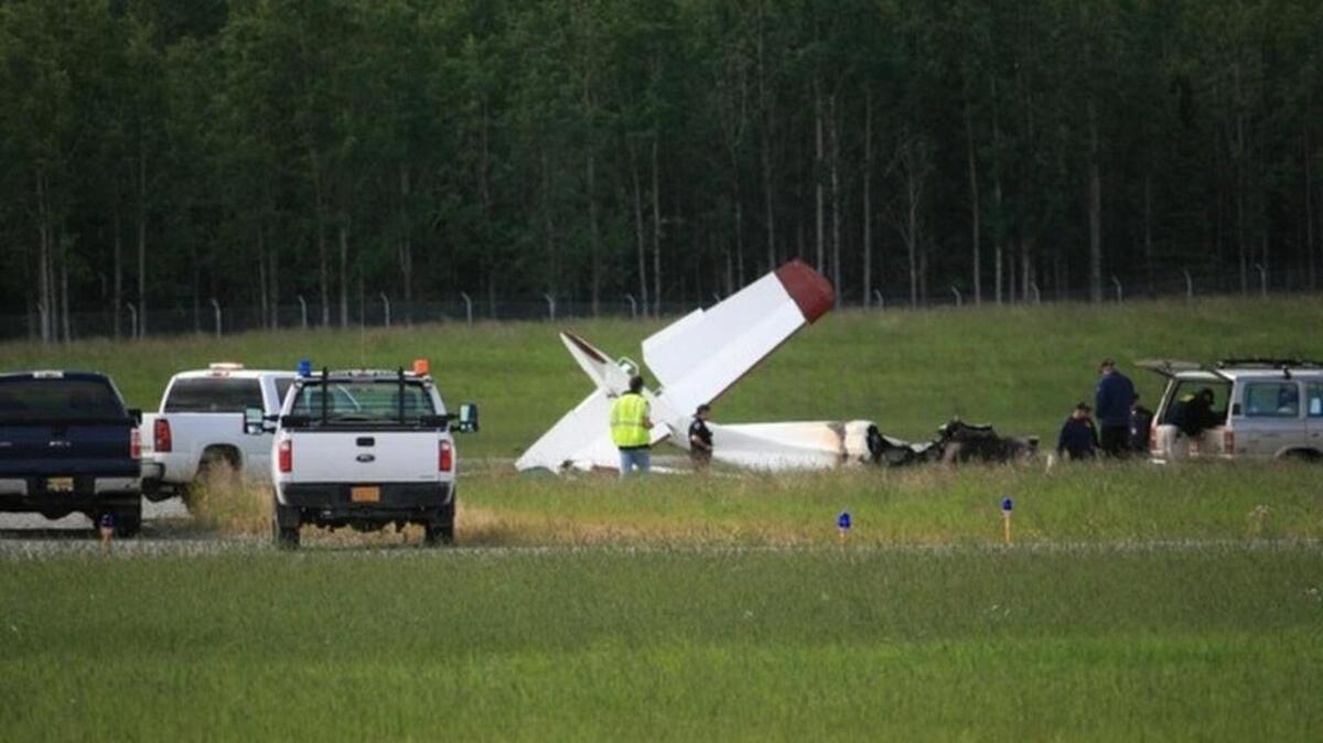 NTSB and FAA investigators comb over the de Havilland DHC-3 Otter crash site Monday afternoon, July 8, 2013 in Soldotna. The national NTSB "go-team" arrived early in the evening to take charge of the investigation.