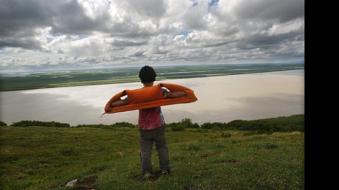 
Edward Prunes, 11, catches the wind while taking in a view of the Yukon Delta atop Azachorok Mountain following a short hike from his home in Mountain Village. 
