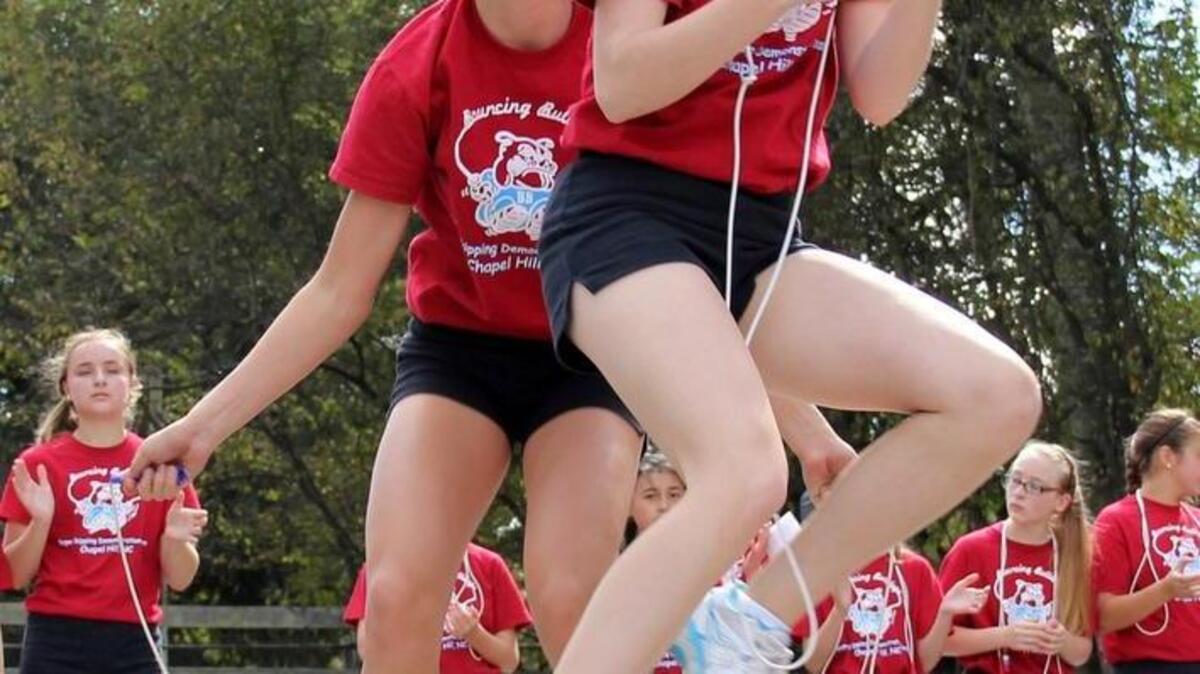 From left, Kenzie Ruston, 15, of East Chapel Hill High, and Anna Reeb, 14, of Carrboro High, perform with the Bouncing Bulldogs in 2013.