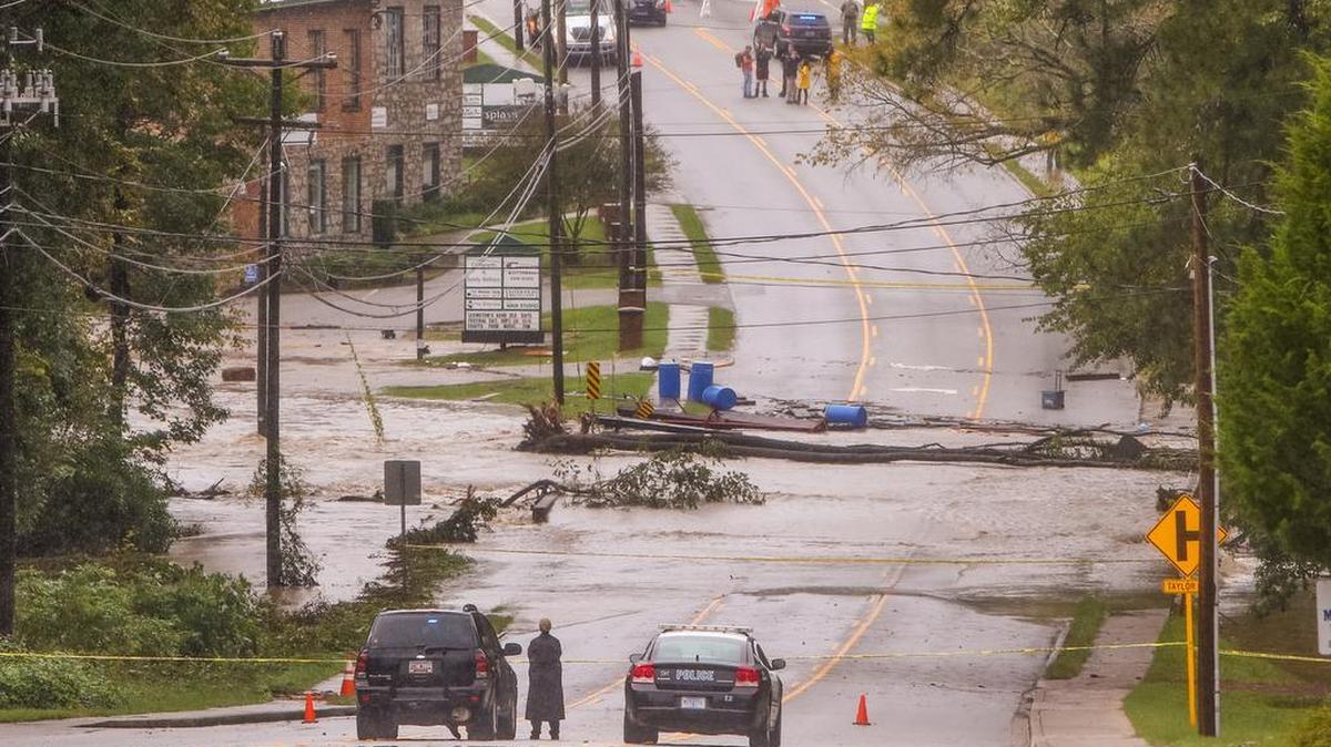 A portion of Main street in Lexington was closed off after flood waters in Twelvemile Creek broke through the Old Mill dam in Lexington.