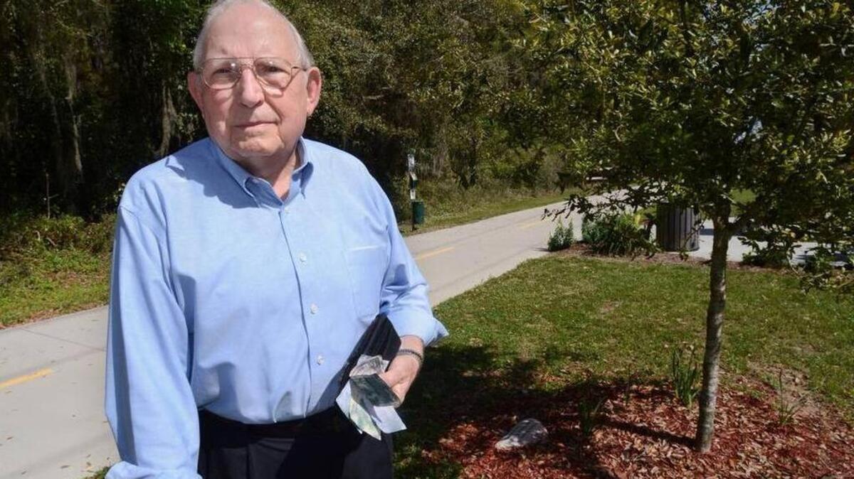 Laurance Davis stands near the tree dedicated to his late grandson that he was tending along the Spanish Moss Trail when he was mugged at gunpoint in August 2015. Some time later, his wife found a wallet left in the spot with a dollar bill and messages of consolation. Since then, Davis has been trying to figure out how to turn this robbery and gift into something positive. He has decided to be an ambassador for fundraising to finish and maintain the trail.
