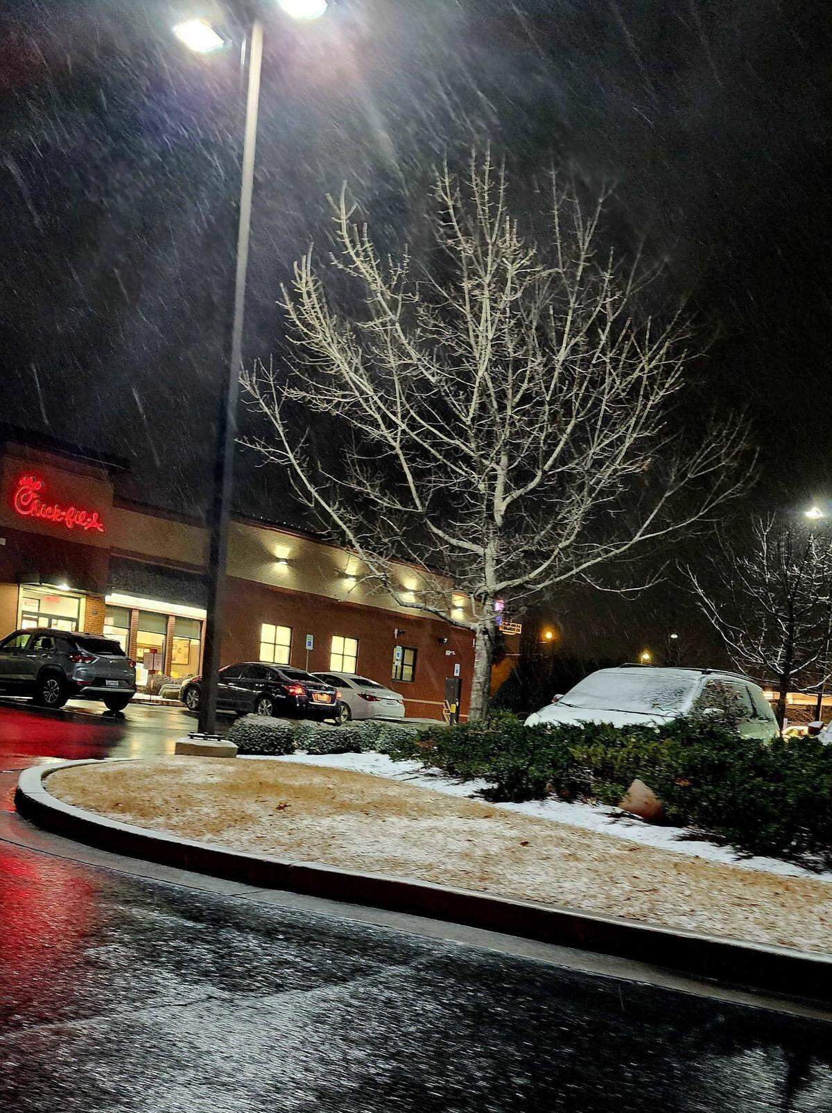 A Chic-Fil-A in Lexington off U.S. 378 remains open as snow accumulates on cars and the ground at around 7 p.m. on Jan. 21, 2025.