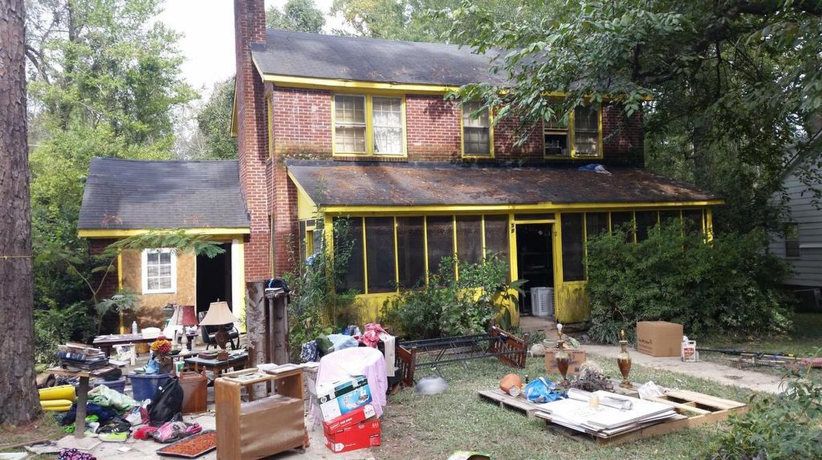 The house from which reporter Jeff Wilkinson was rescued. On the night of the flood, water reached the yellow trim line on the screened porch. The house's occupants escaped by crawling out a second-story window, onto the porch roof and into the boat.