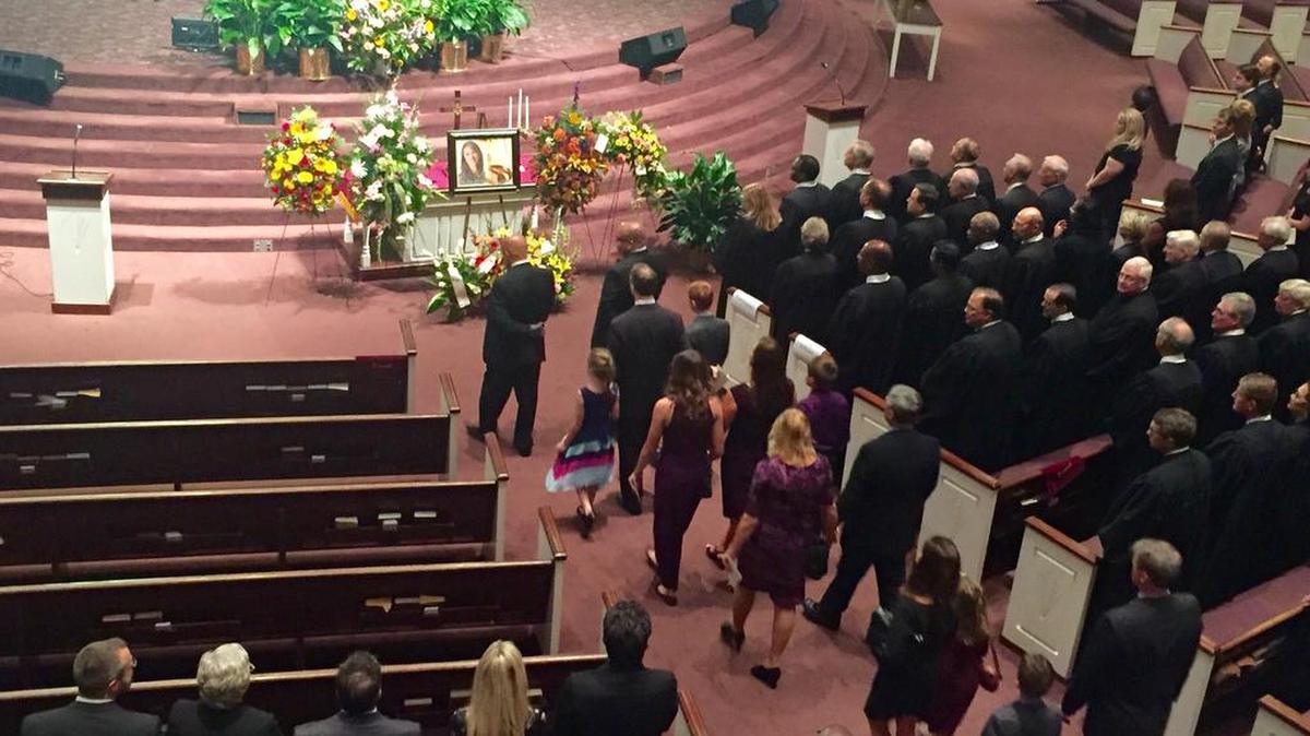 Judge Tanya Gee’s family, led by her husband, Chris, and children, Sabin and Will, walk into her memorial service Wednesday. Beside them, dozens of robed judges fill the pews to pay honor to the beloved circuit judge, who died Sept. 28.