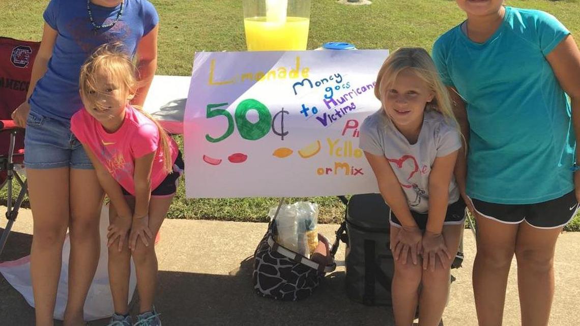 (From the left) Elle Lockard, Anna Fuller, Amelia Neese, and Abby Fuller pose in front of the lemonade stand where $145 dollars in hurricane relief was raised in one weekend.