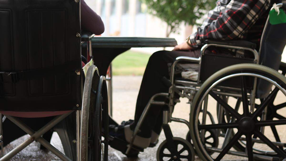 This file photo shows two people in wheelchairs at a nursing home.