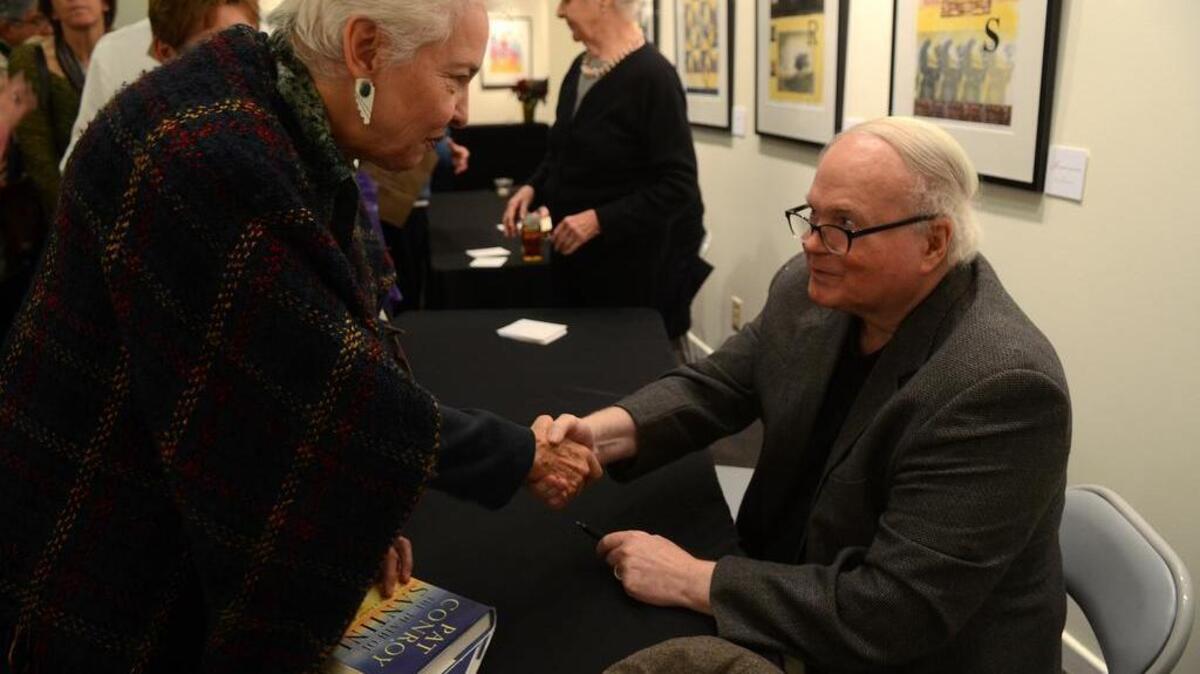 Beaufort author Pat Conroy shakes hands with a fan during a book signing on Dec. 8, 2014, at the University of South Carolina Beaufort Center for the Arts in Beaufort.