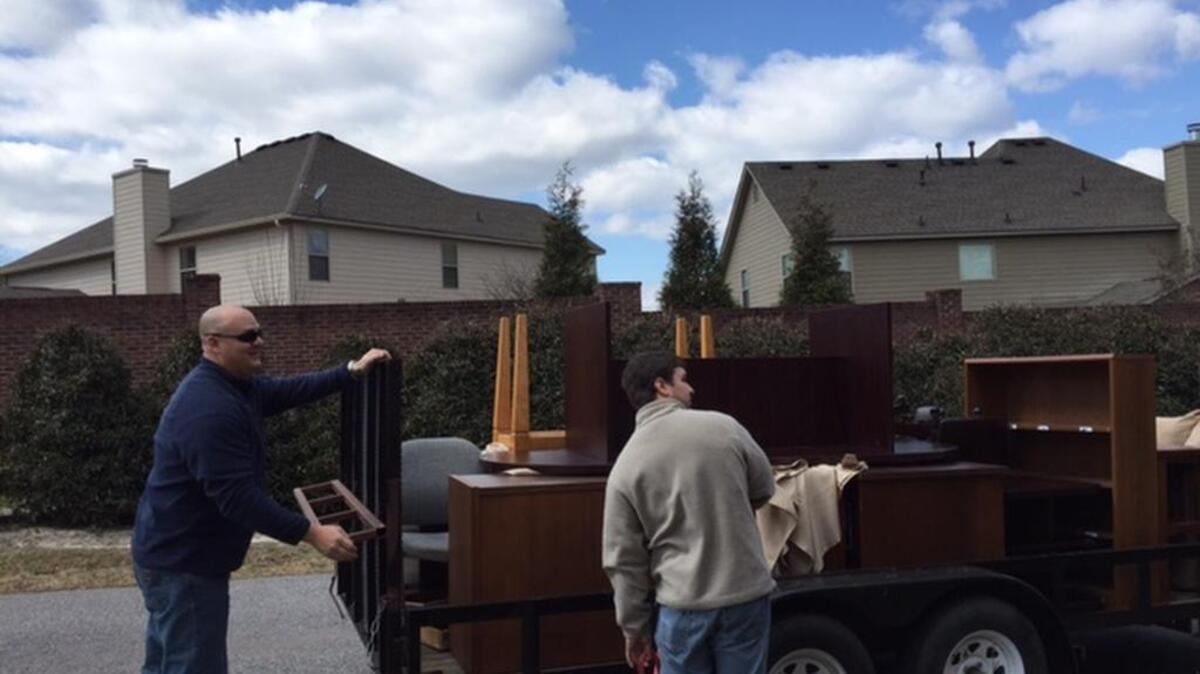 Lexington County deputy Ben Strock, left, helps Heyward Barnes, a member of the board overseeing the Dickerson Children’s Advocacy Center, move into its new office over the weekend.