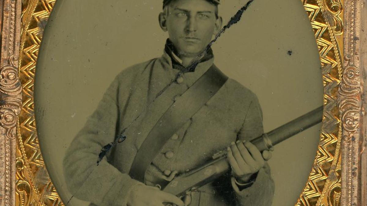 This undated photo made available by W. C. Smith shows Pvt. William Stinson, a Confederate soldier in the 45th Georgia Infantry, wearing a British cartridge box, a British belt while holding a British musket. The Confederate Relic Room and Military Museum in Columbia, S.C., has purchased a large collection of British-imported Confederate weapons and other related items.
