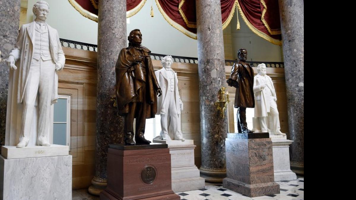 A statue of Jefferson Davis, second from left, remains on display in Statuary Hall on Capitol Hill in Washington.
