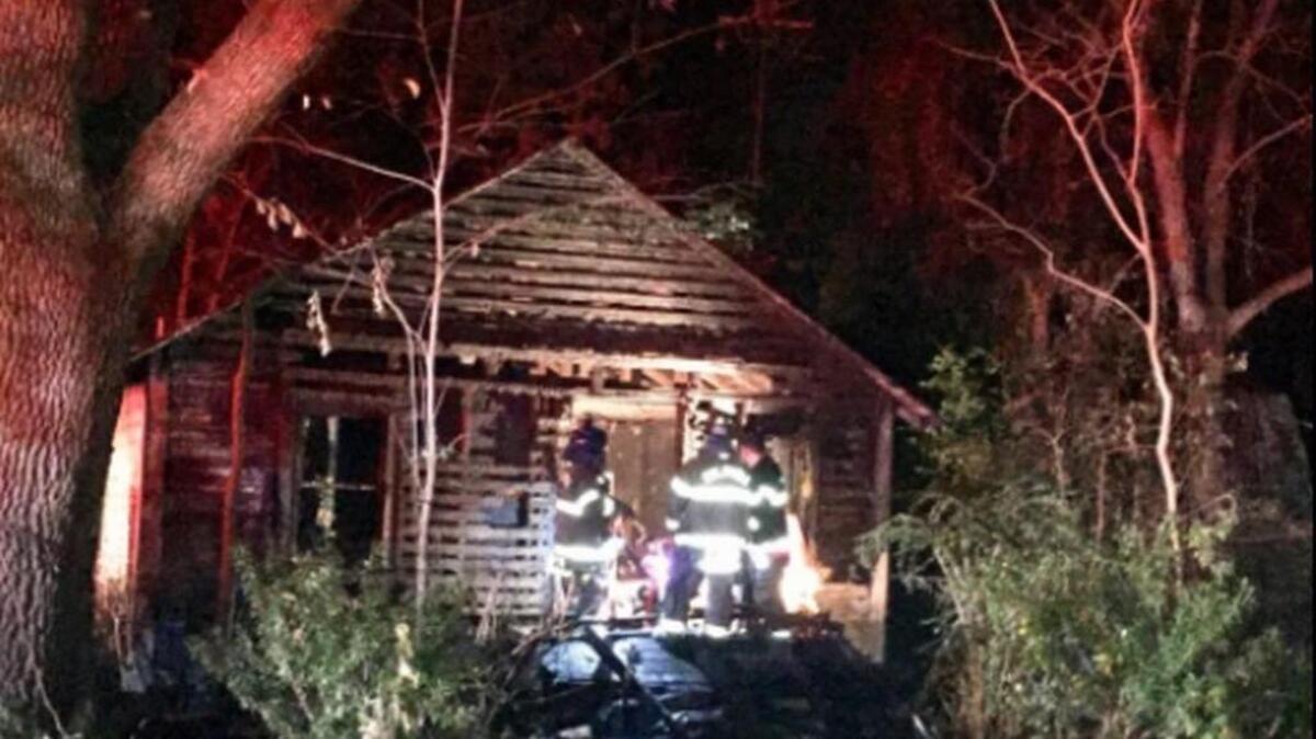 Columbia firefighters search through an abandoned house on Carver Street that caught fire.
