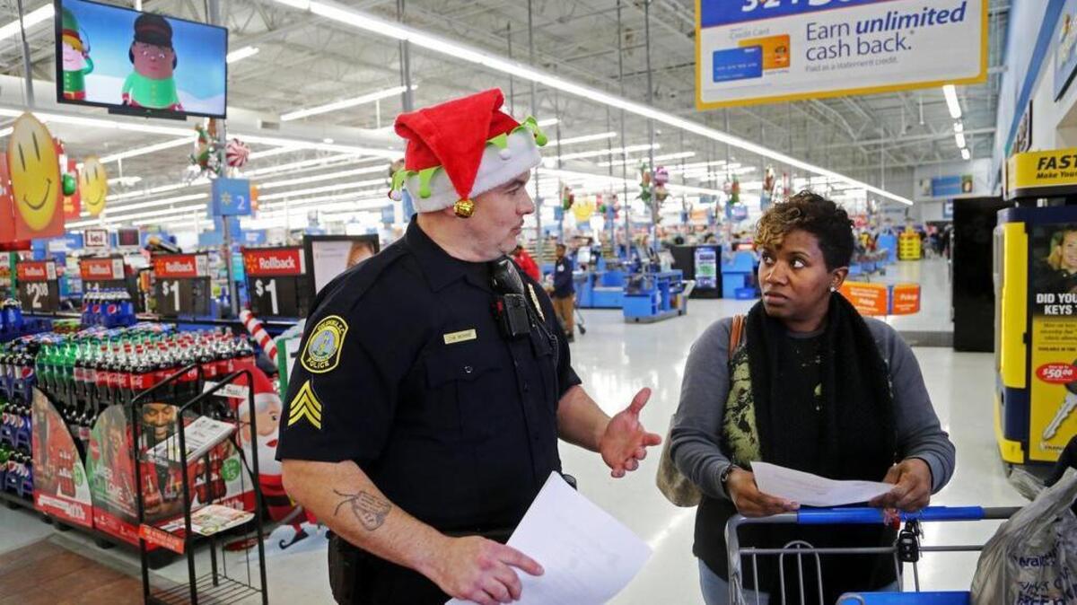 Officer Christopher Morris shares some safety tips with Darnetta Murrell inside the Wal-Mart on Forest Drive in Columbia, SC, Monday, December 12, 2016. Columbia police officers handed out safety tips for shoppers this holiday season and helped load big items into their cars.