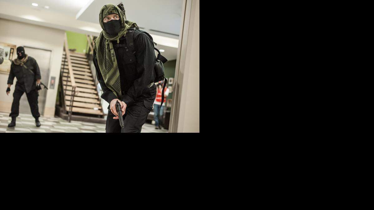 
Bob Landrum and Rick Ellis play the roles of active shooters in a training exercise Tuesday at Fort Jackson. The scenario involved two shooters and emergency responders from various departments. 
