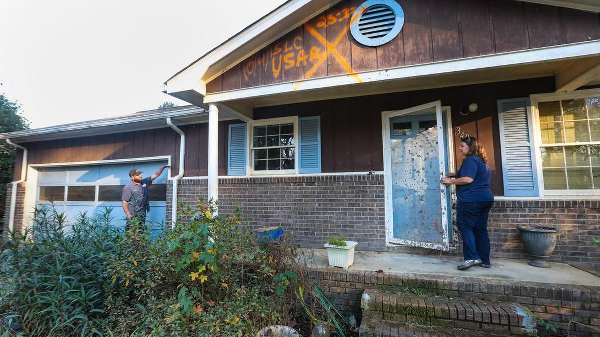 Logan Grillot and fiance Dennis Lester are struggling with the excruciatingly slow pace of government agencies over their flood-damaged home in Pine Glen neighborhood. Five feet of water submerged all of their belongings and left them with a mold-infested home.
