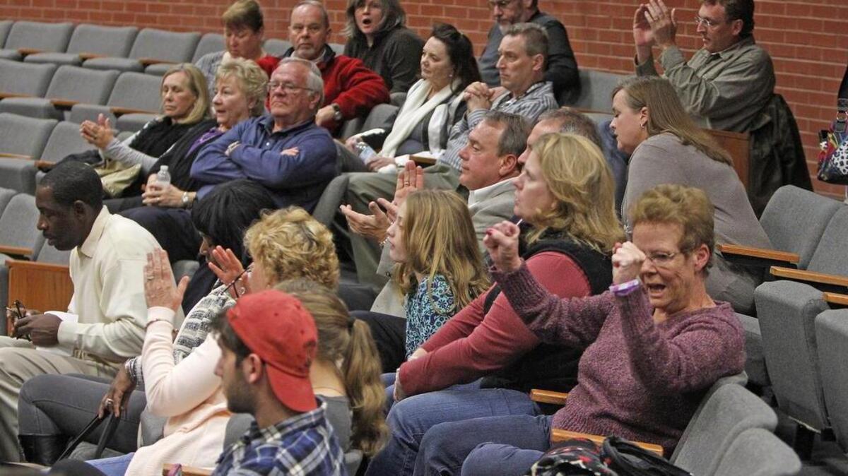 A large crowd reacts after Richland County council members voted to deny a zoning request on proposed commercial development on Rimer Pond Road in Blythewood.