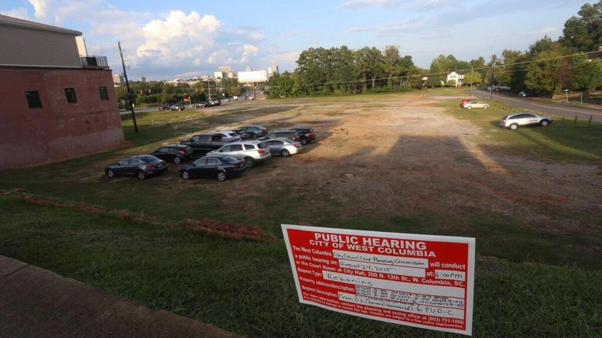 
Parked cars line up Friday in “The Pit” in West Columbia where a developer wants to put residential units, shops, offices and restaurants. 
