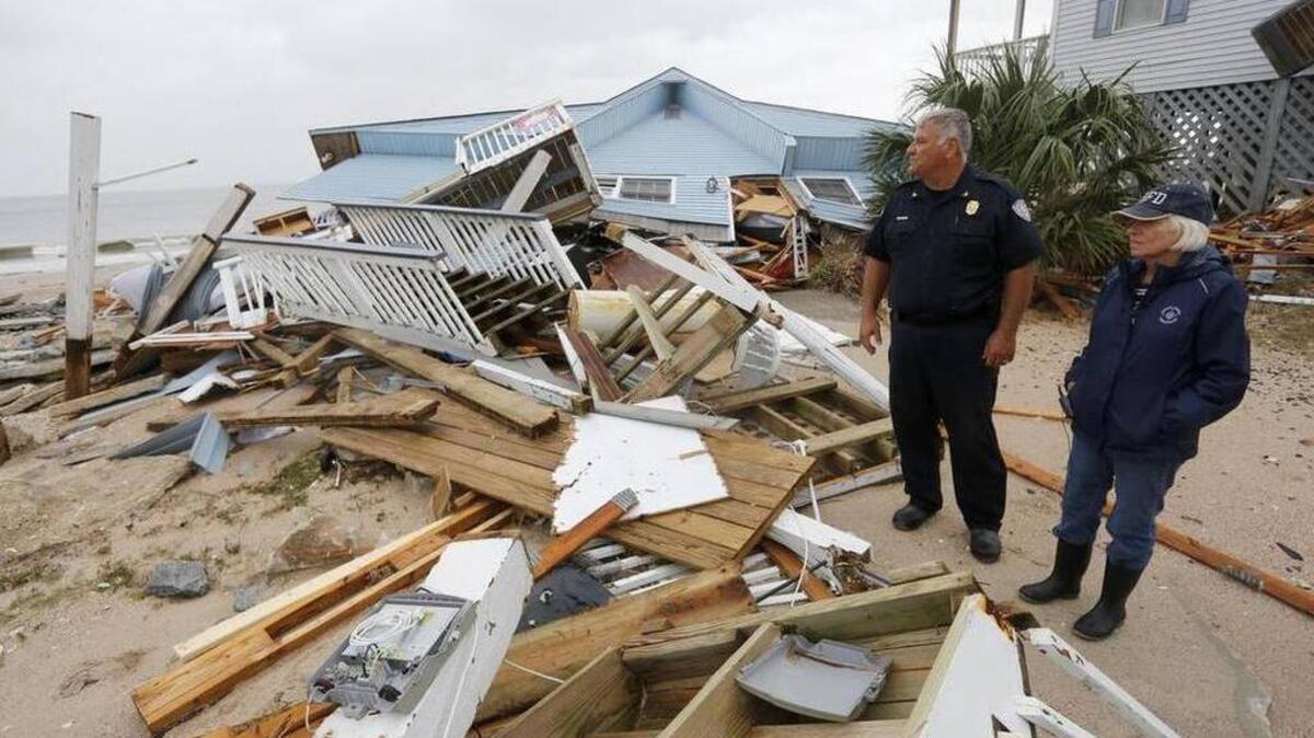 Town of Edisto Beach Chief of Police George Brothers, left, and Mayor Jane Darby survey the damage done to homes along Palmetto Blvd after Hurricane Matthew slammed into their tiny beach community Saturday.