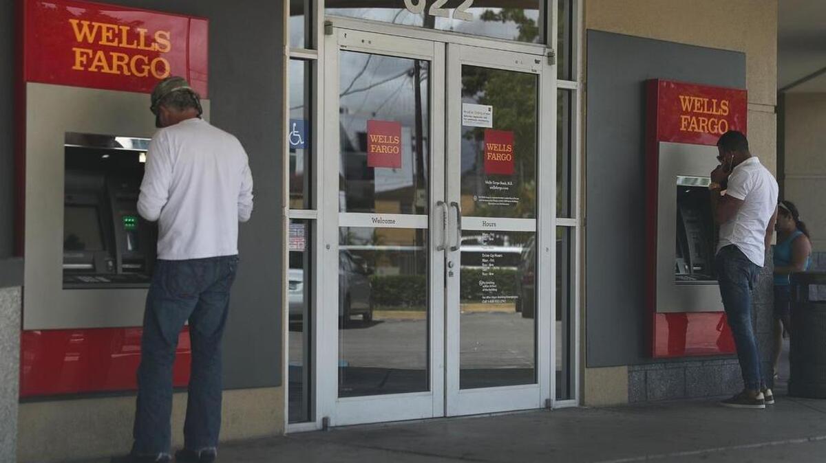 Customers use a Wells Fargo automated teller machine at a Miami branch in this September 2016 photo.