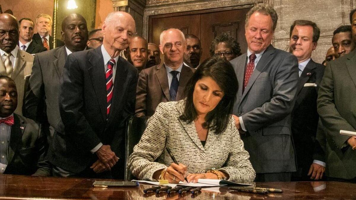 
Gov. Nikki Haley signs legislation in July to remove the Confederate flag from the State House grounds. Haley on Thursday night was honored by the Columbia Chamber as its Ambassador of the Year. The chamber cited Haley’s efforts to remove the flag.
