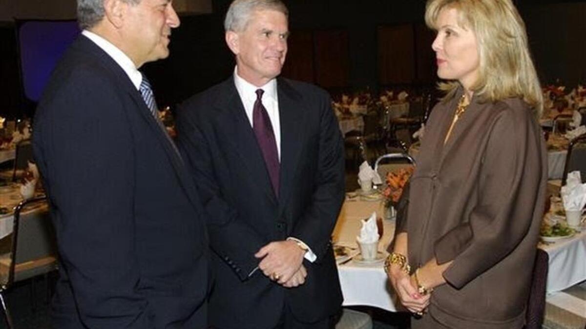 
FILE - In this Oct. 18, 2002 file photo, Richard Rainwater, left, and his wife Darla Moore, right, talk with Clemson University President Jim Barker before announcing a gift of $10 million to the university in Clemson, S.C. Rainwater, the son of a North Texas grocer who went on to amass a fortune as an investment manager before becoming a billionaire investor and philanthropist in his own right, has died, Sunday, Sept. 27, 2015, according to his charitable foundation. He was 71. (Mark Crammer/The Independent-Mail via AP, File) 
