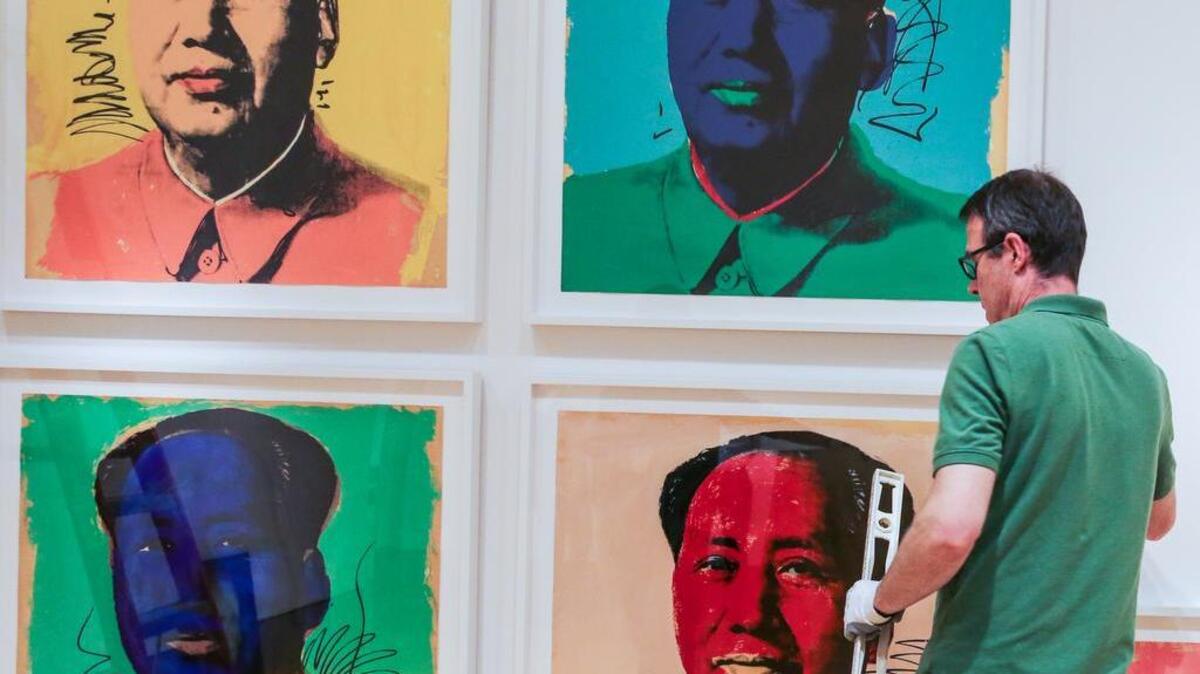 
Michael Dwyer, preparator and exhibit designer, in June hangs portraits for the “From Marilyn to Mao, Andy Warhol's Famous Faces” exhibit at the Columbia Museum of Art. The show will be at the museum until Sept. 13.

