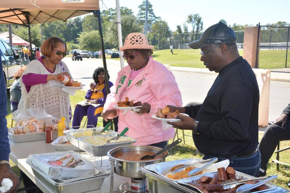 Tailgating and merrymaking with friends and family before and during Benedict College’s homecoming football game is a tradition for graduates and fans alike. This year’s homecoming game on Oct. 22, 2016, is a battle of the tigers as the Benedict Tigers play the Morehouse College Tigers. Here, from left, Robin Duren (Class of 1979), Arlene Lathan and Larry Tidwell fix their plates at the Belk Brother’s tailgating tent.