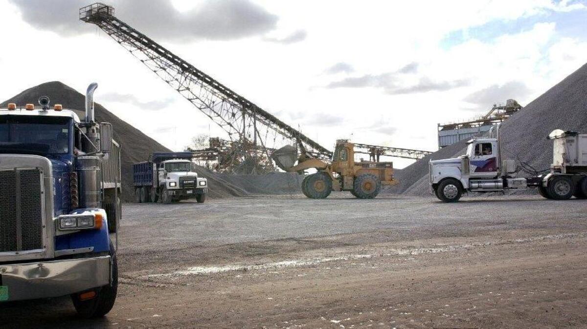 
Vulcan Materials granite quarry in Columbia in Olympia section. The trucks are loaded with rock from the stockyard pile.
