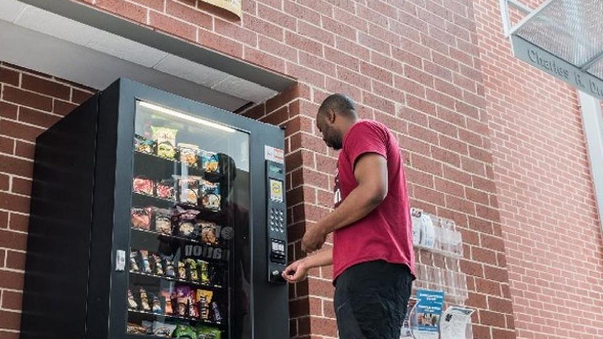 Columbia resident Marcus Raven purchases Fig Newtons at the Drew Wellness Center