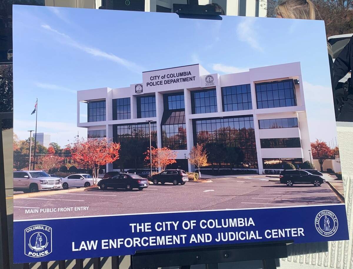 A board on a tripod showing a rendering of what the new facility will look like. 
